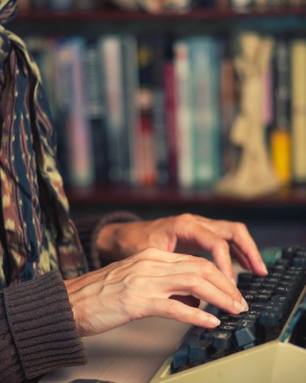 woman typing on an old fashioned typewriter